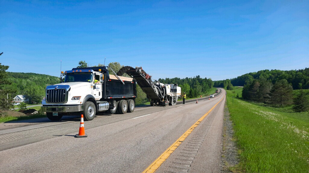 A milling machine grinds pavement along Interstate 91 between Barton and Derby, VT.