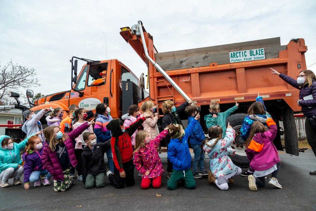 Students at Porters Point Elementary School point to their newly-named plow: Arctic Blaze