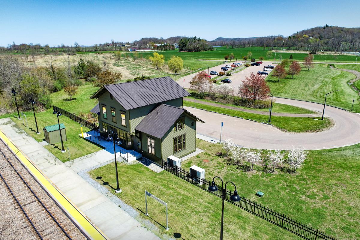 An aerial photo of the new Amtrak platform and restored depot station Vergennes at the Ferrisburgh Park and Ride off of VT Route 22A near Route 7