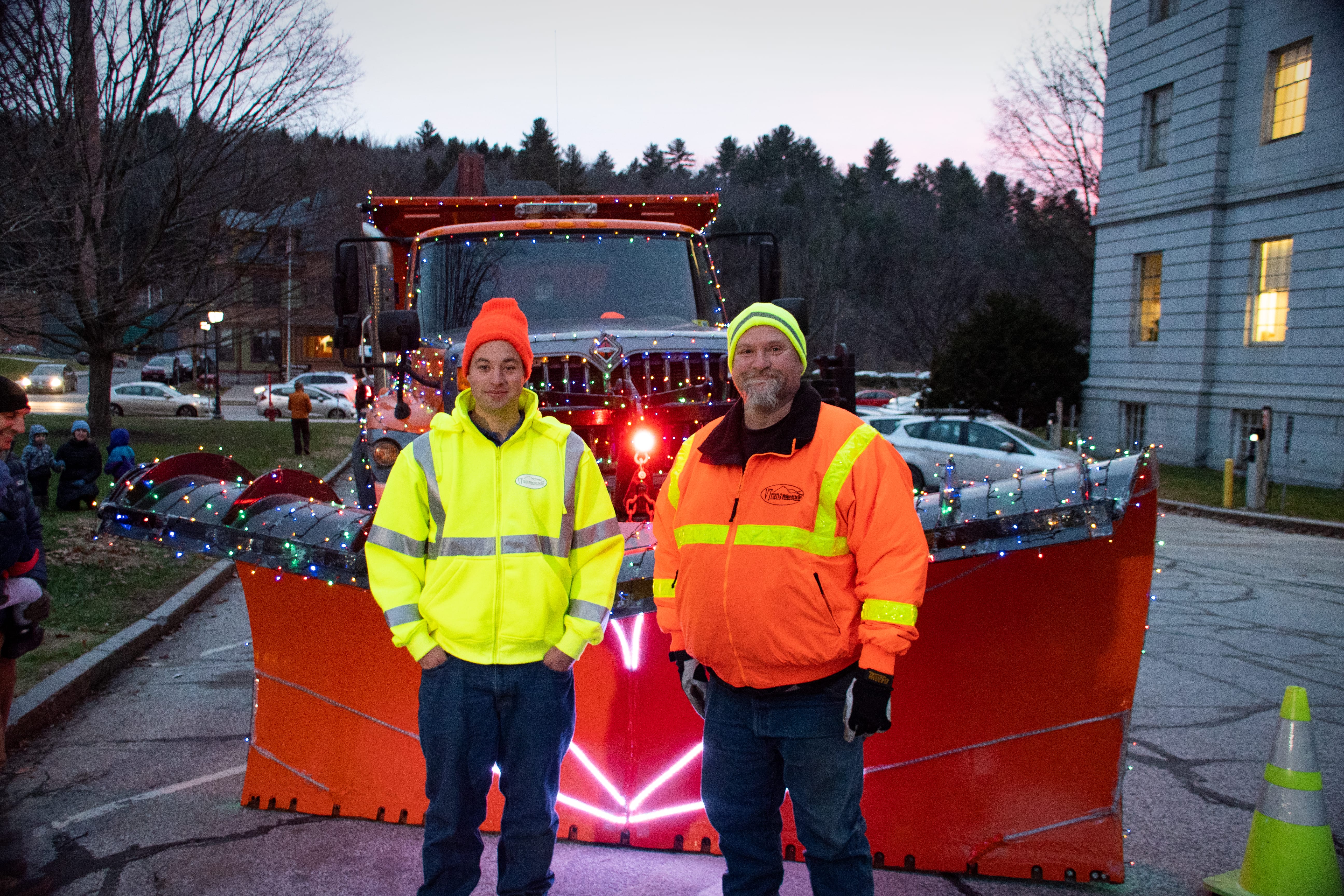 Civil Engineer, Iain Portalupi, and Maintenance Supervisor and plow driver, John Dunbar, pose in front of Rudolph the Snowplow