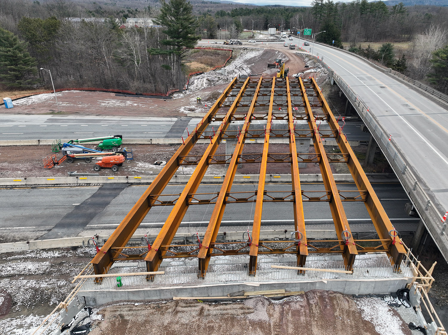 Crews construct the new U.S. 2 bridge over I-89 at Exit 17 adjacent to the existing bridge in Colchester, VT.