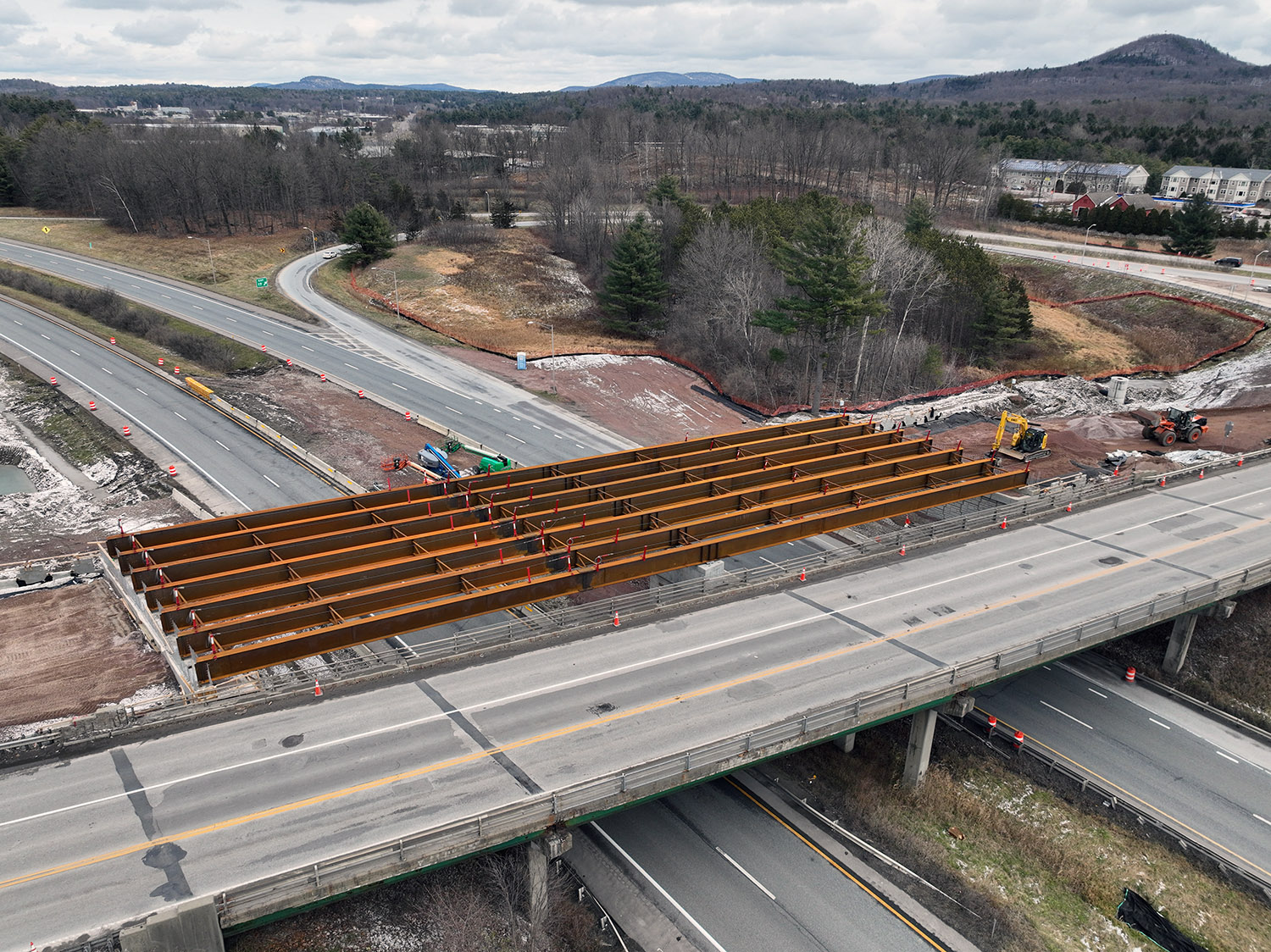 Crews construct the new U.S. 2 bridge over I-89 at Exit 17 adjacent to the existing bridge in Colchester, VT.