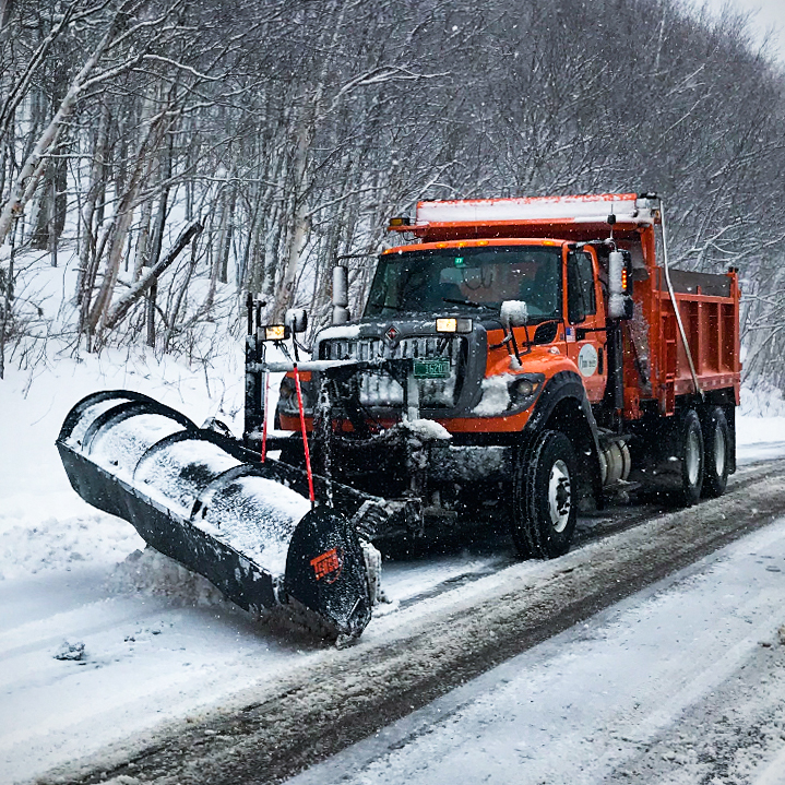 A VTrans snowplow travels down the VT Route 242 in Jay during a snow event.