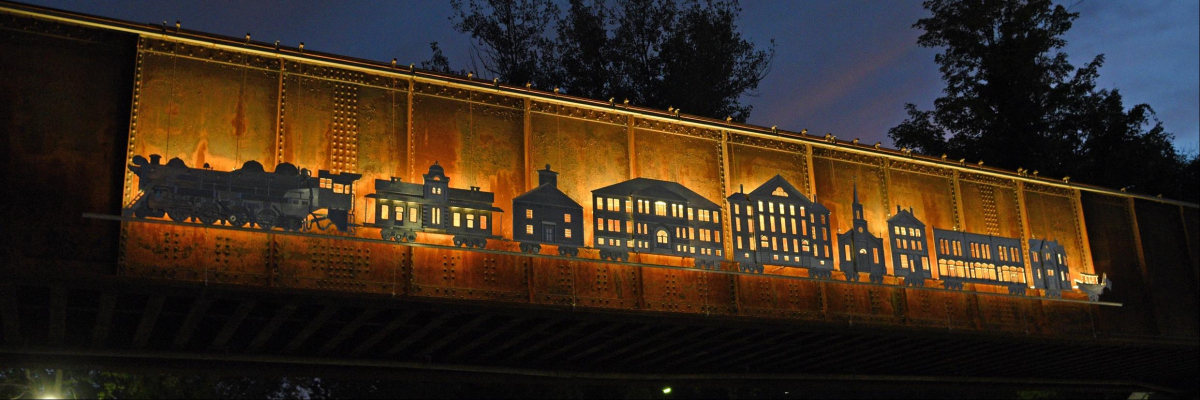 Image of art on side of train at night.