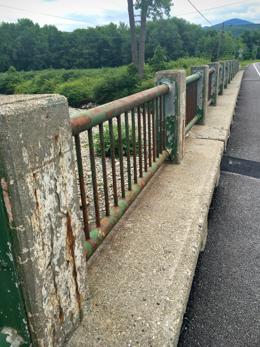 Existing Bridge #20 - showing visible signs of wear and weather on the metal and concrete railing.