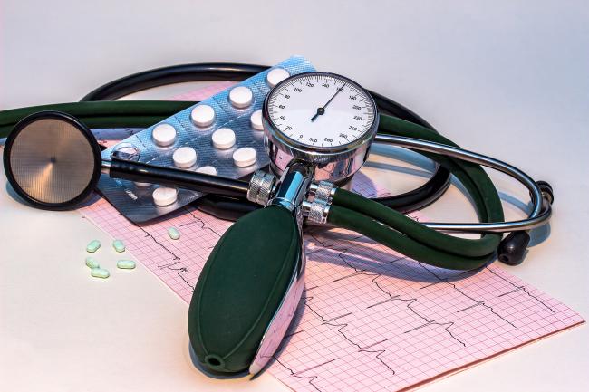 Blood Pressure cuff, pills and medical record